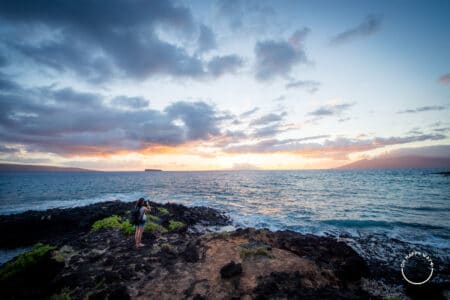 Bruna admirando o pôr do sol na praia de Makena. Maui, Havaí.