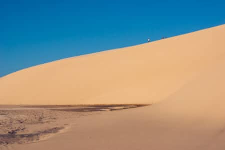 Pessoas na duna do pôr do sol