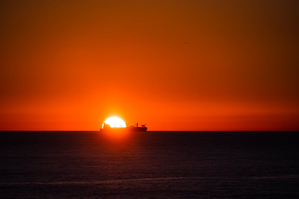 Pôr do sol sobre um navio visto da praia do Carneiro, na cidade do Porto